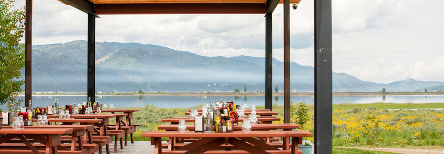 View of picnic tables and mountains in background.